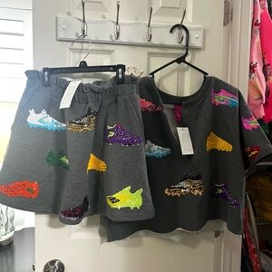 QUEEN OF SPARKLES Gray Sequin cleats Set. NWT. Top is an L, skort is a M.